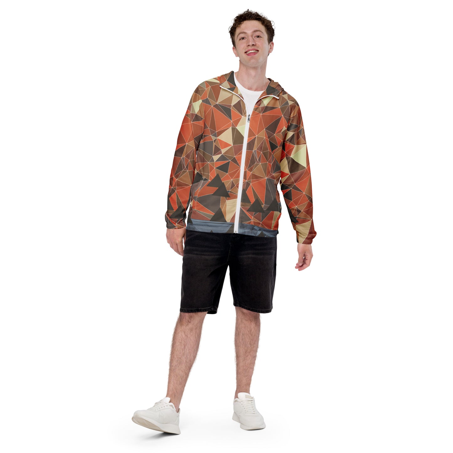 Person wearing a multicolor geometric patterned windbreaker jacket on a white background