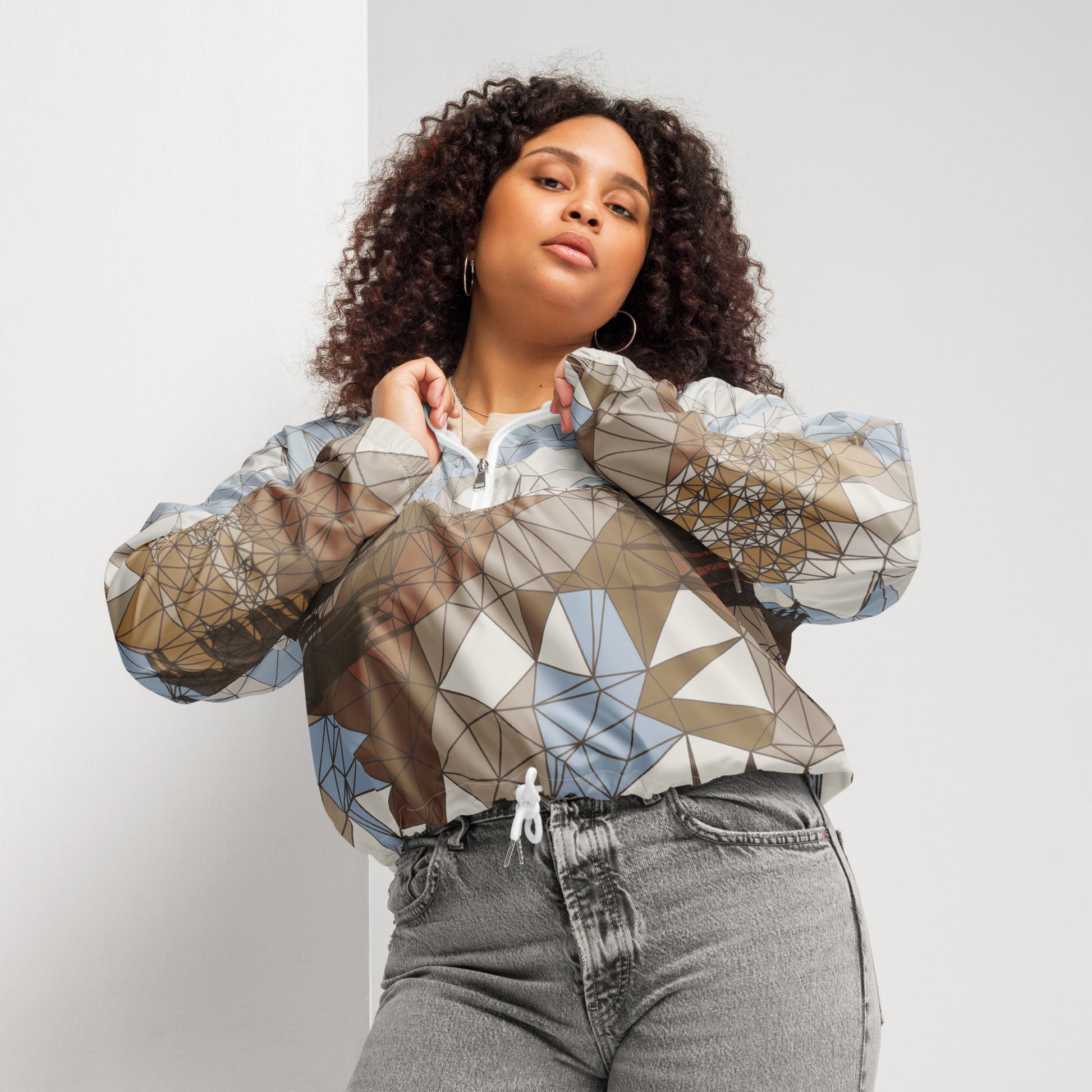 Woman wearing a geometric patterned jacket against a plain background