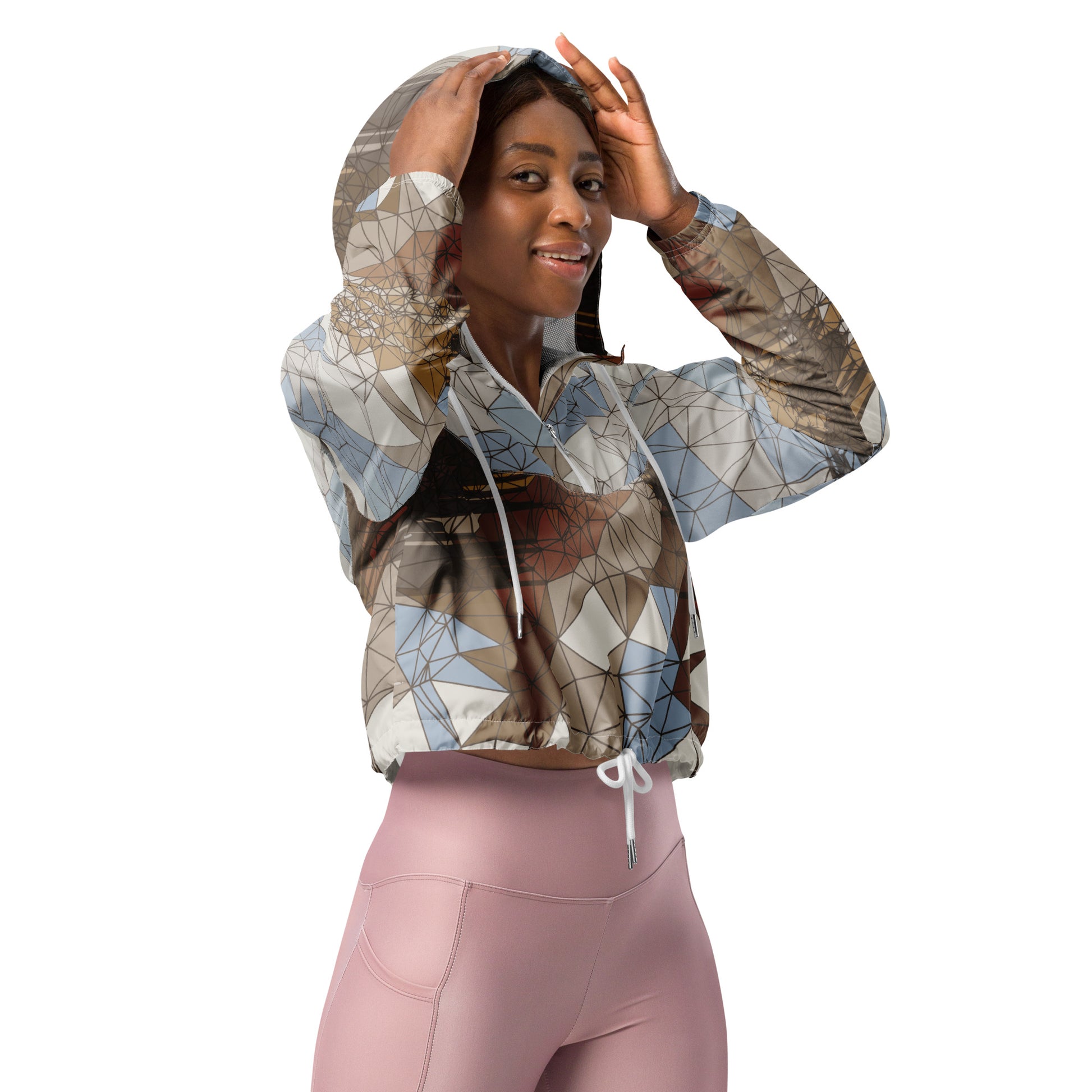 Woman wearing a patterned windbreaker and pink leggings on a white background
