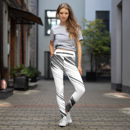 Woman wearing a gray t-shirt and white black stripe leggings with waistband brand logo 'Funwearcode' on a street.